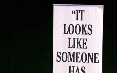 Man With Microphone Behind Sign Saying It Looks Like Someone Has GIF
