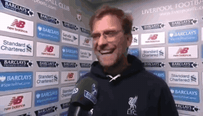 Man With Microphone In Front Of Barclays And New Balance Ads GIF