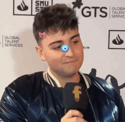 Man With Microphone In Front Of GTS Wall GIF