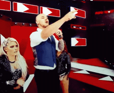 Man With Microphone Pointing As Woman Watches GIF