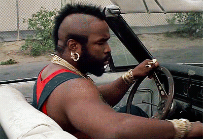 Man With Mohawk And Earrings Driving Convertible GIF