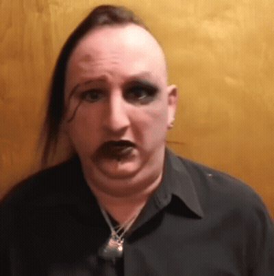 Man With Mohawk And Necklace Making Funny Face GIF