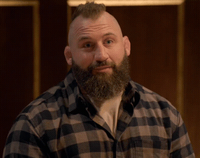 Man With Mohawk Beard And Plaid Shirt Looking At Camera GIF