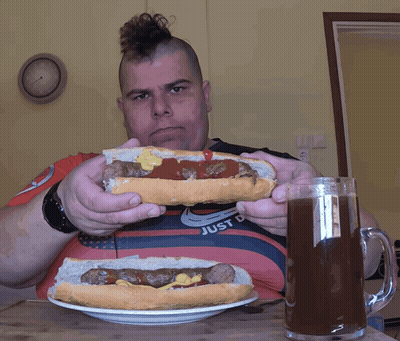 Man With Mohawk Eating Hot Dog GIF