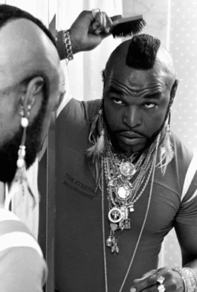 Man With Mohawk Looking In Mirror GIF