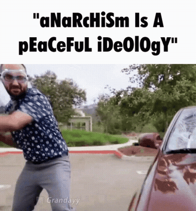 Man With Mohawk Sitting At Table GIF