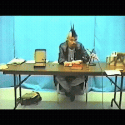 Man With Mohawk Sitting At Table GIF