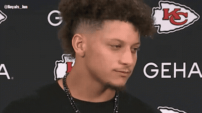 Man With Mohawk Smiling In Front Of GEHA Sign GIF