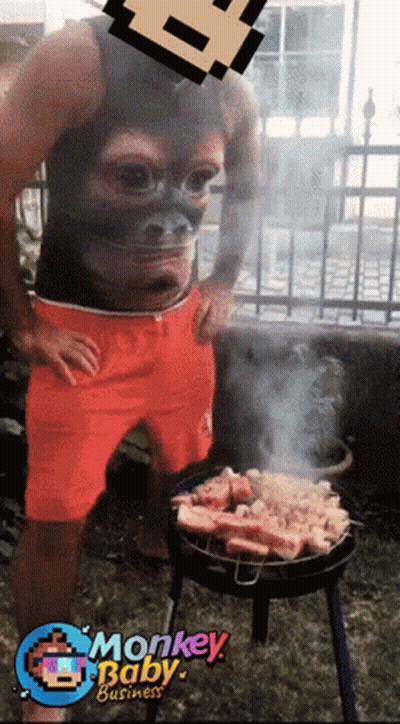 Man With Monkey Face Shirt Grilling Meat GIF