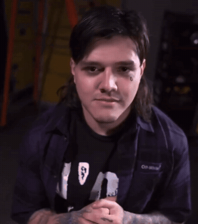 Man With Mullet Smiling And Waving GIF