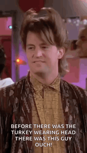 Man With Mullet Standing In Room With Purple Background GIF