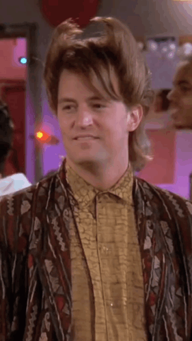 Man With Mullet Wearing Jacket And Shirt Smiling GIF