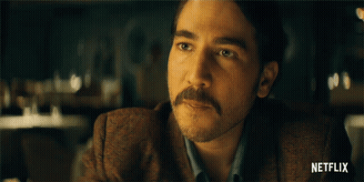Man With Mustache At Table With Netflix Logo GIF
