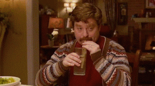 Man With Mustache Drinking From Glass At Table GIF