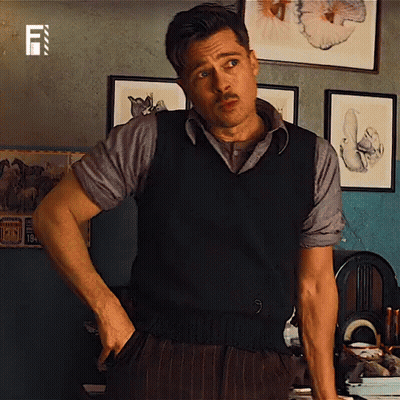 Man With Mustache Hands In Pockets In Room With Pictures GIF