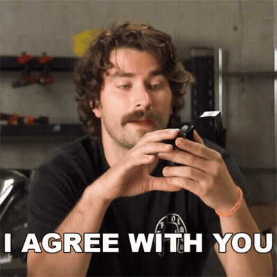 Man With Mustache Holding Cell Phone Saying I Agree GIF