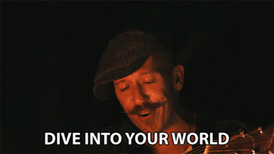 Man With Mustache Holding Guitar Says Dive Into Your World GIF