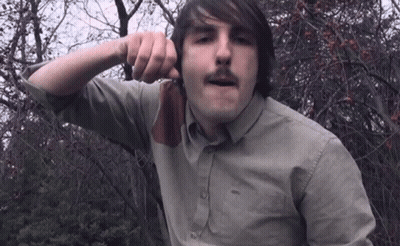 Man With Mustache Holding Knife To Face GIF
