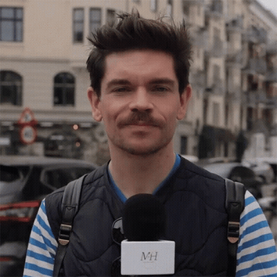 Man With Mustache Holding Microphone With MH GIF