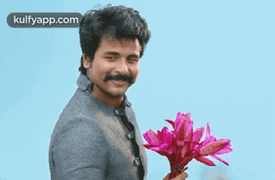 Man With Mustache Holding Pink Flowers Smiling GIF