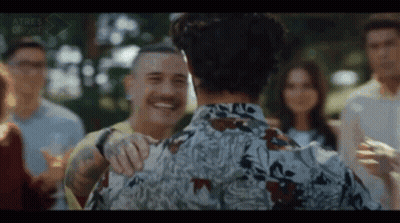 Man With Mustache Hugging Another In Group GIF