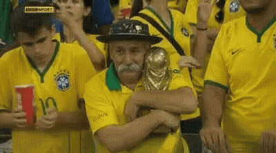 Man With Mustache Hugging Trophy In Crowd GIF