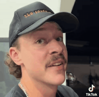 Man With Mustache In Black Hat GIF