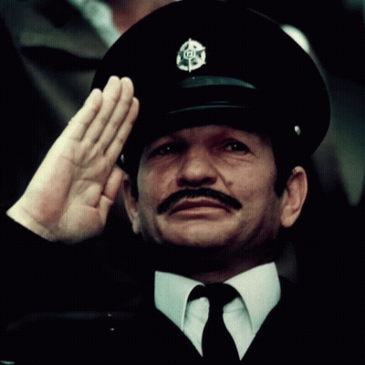 Man With Mustache In Black Hat With 101 Badge GIF