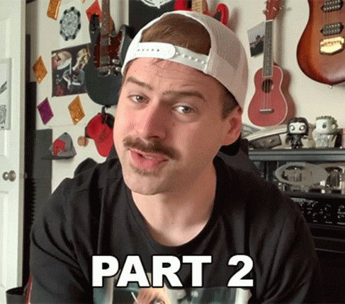 Man With Mustache In Black Shirt And White Hat Says Part 2 GIF