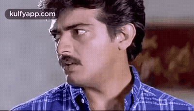 Man With Mustache In Blue Plaid Shirt Looking At Camera GIF