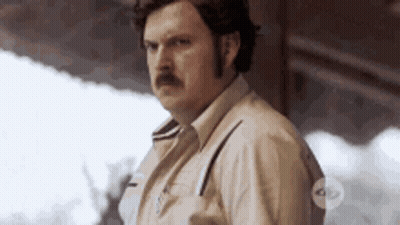 Man With Mustache In Front Of Building GIF