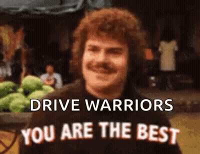 Man With Mustache In Front Of Drive Warriors Sign GIF