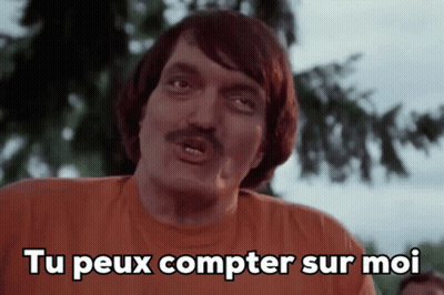 Man With Mustache In Orange Shirt Saying Tu Peux Compter Sur Moi GIF
