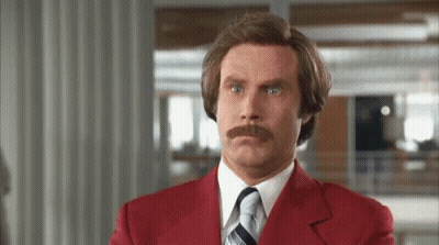 Man With Mustache In Red Suit Making Funny Face GIF