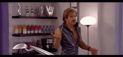 Man With Mustache In Room With Lamp And Bottles GIF