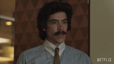 Man With Mustache In Striped Shirt And Tie With Netflix Logo GIF