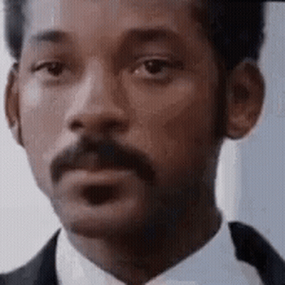 Man With Mustache In Suit And Tie Looking At Camera GIF