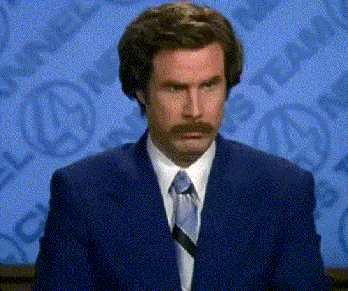 Man With Mustache In Suit And Tie Making Funny Face GIF