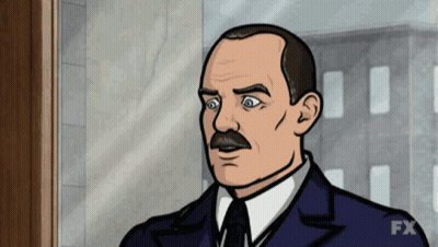 Man With Mustache In Suit And Tie Standing In Front Of Window GIF