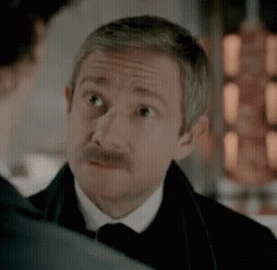 Man With Mustache In Tuxedo Looking At Another Man GIF