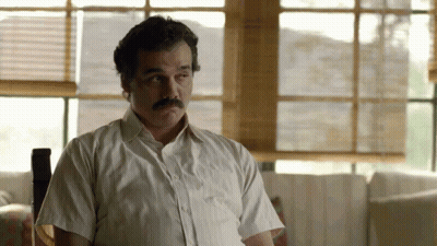 Man With Mustache In White Shirt Sitting By Window GIF