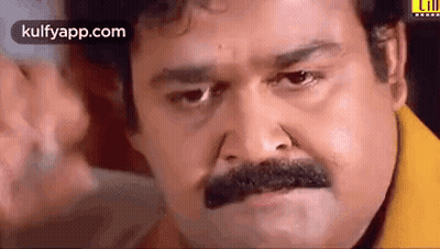 Man With Mustache In Yellow Shirt Making Face GIF