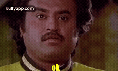 Man With Mustache In Yellow Shirt Making Funny Face Saying Ok GIF