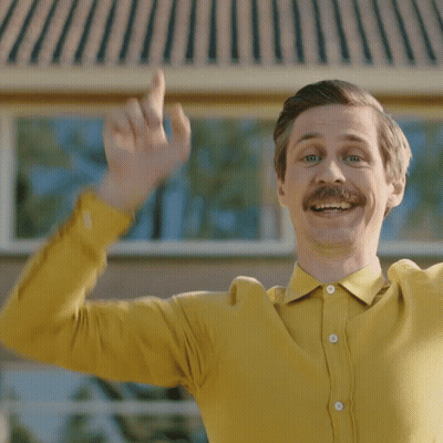 Man With Mustache In Yellow Shirt Waving GIF