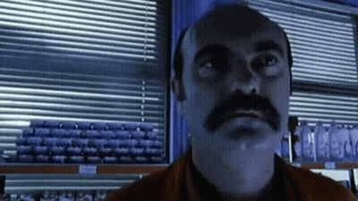 Man With Mustache Looking At Camera GIF