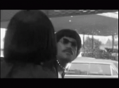 Man With Mustache Looking At Woman In Car GIF