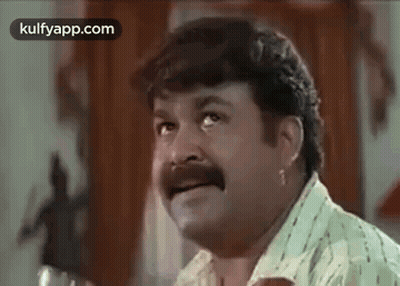 Man With Mustache Making Funny Face At Table GIF