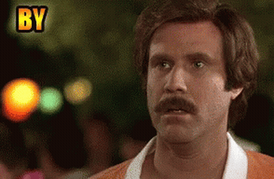 Man With Mustache Making Funny Face In Front Of By Sign GIF