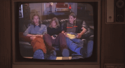 Man With Mustache Next To Man In Orange And Black Shirt GIF