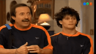 Man With Mustache Next To Man In Orange And Black Shirt GIF